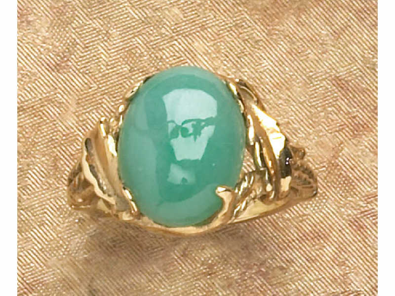 Appraisal: JADE RING Yellow gold ring set with one oval cabochon