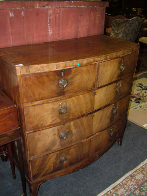 Appraisal: A mahogany bowfront chest th century of two short and