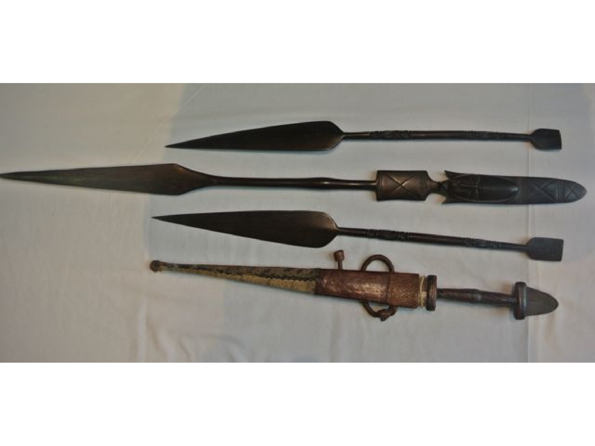 Appraisal: Three African hardwood spears with carved detail and a north