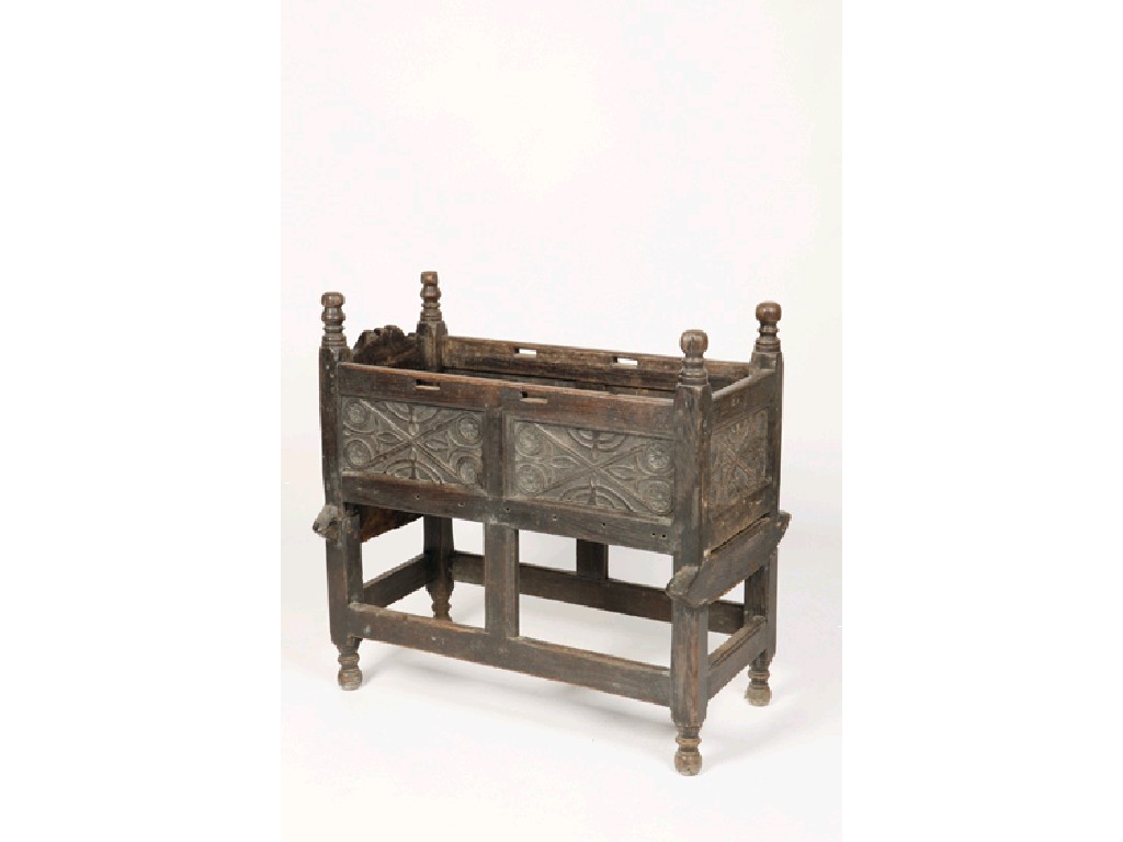 Appraisal: A QUEEN ANNE OAK CRADLE with raised turned uprights and