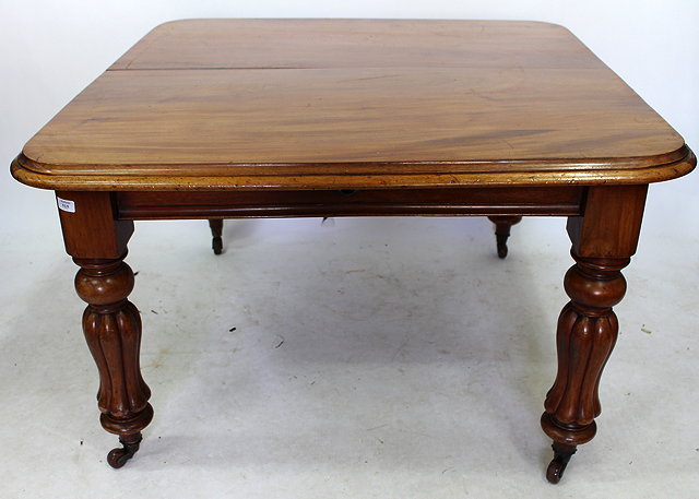 Appraisal: A VICTORIAN MAHOGANY WIND OUT DINING TABLE with carved turned