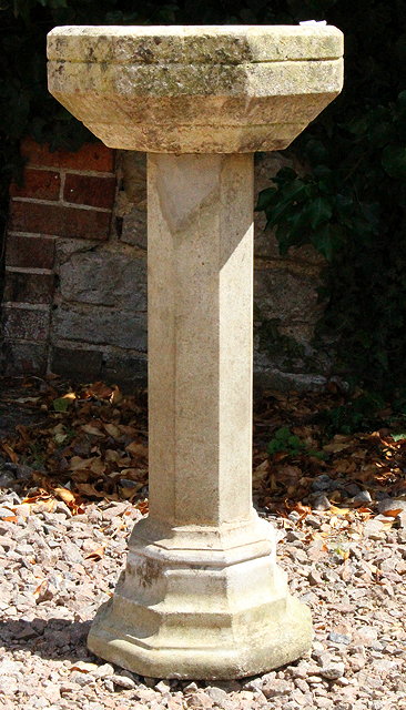 Appraisal: A CARVED STONE OCTAGONAL BIRD BATH on a composite stone