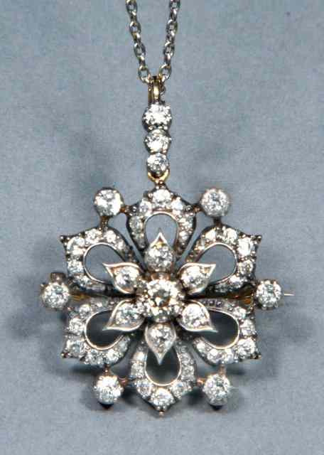 Appraisal: AN EDWARDIAN DIAMOND SET PENDANT BROOCH with central diamond set