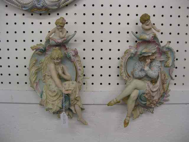 Appraisal: Pair of Figural Bisque Plaques man woman child above dimensional