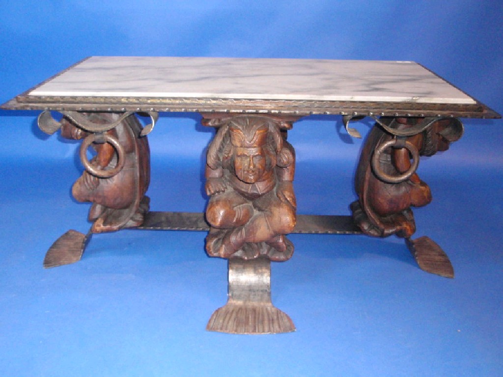 Appraisal: A wrought and anodised coffee table with marble inset top