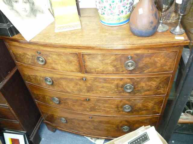 Appraisal: A REGENCY MAHOGANY BOW FRONTED CHEST of two short over