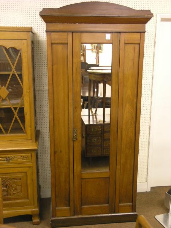 Appraisal: A late Victorian solid walnut wardrobe enclosed by full length