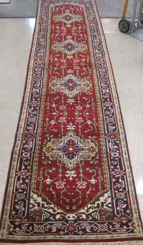 Appraisal: HAND KNOTTED ORIENTAL HALL RUG Persian Serapi design with red