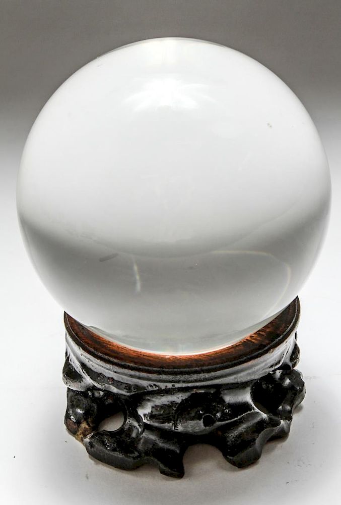 Appraisal: Crystal Ball in Carved Ebonized Stand Magnifying crystal ball in