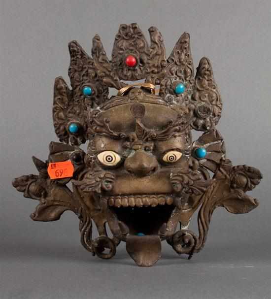 Appraisal: Tibetan brass mask-form censer th century with applied bone and