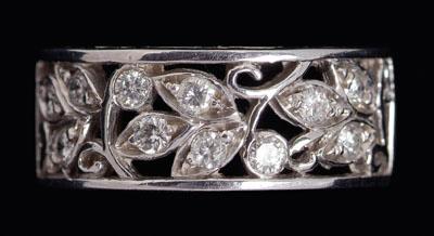 Appraisal: Diamond band openwork floral decoration accented with round brilliant-cut diamonds