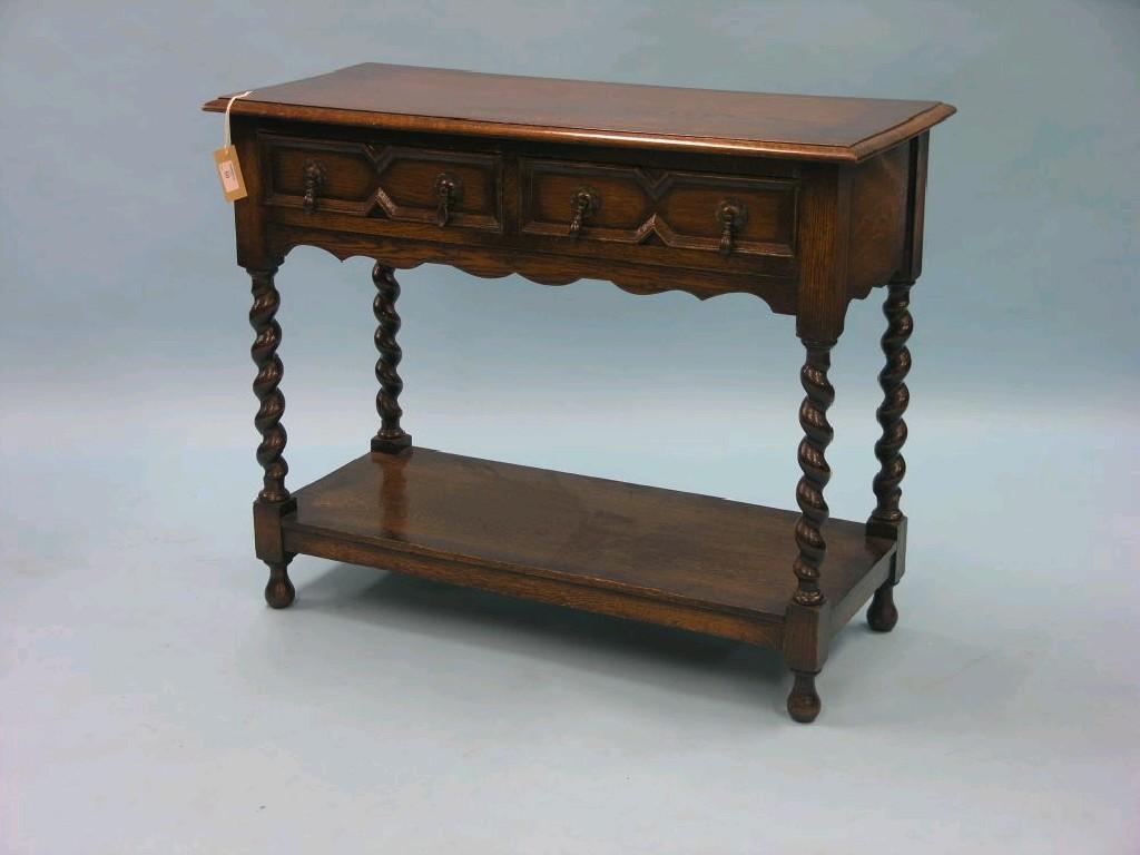 Appraisal: A solid dark oak side table with two frieze drawers