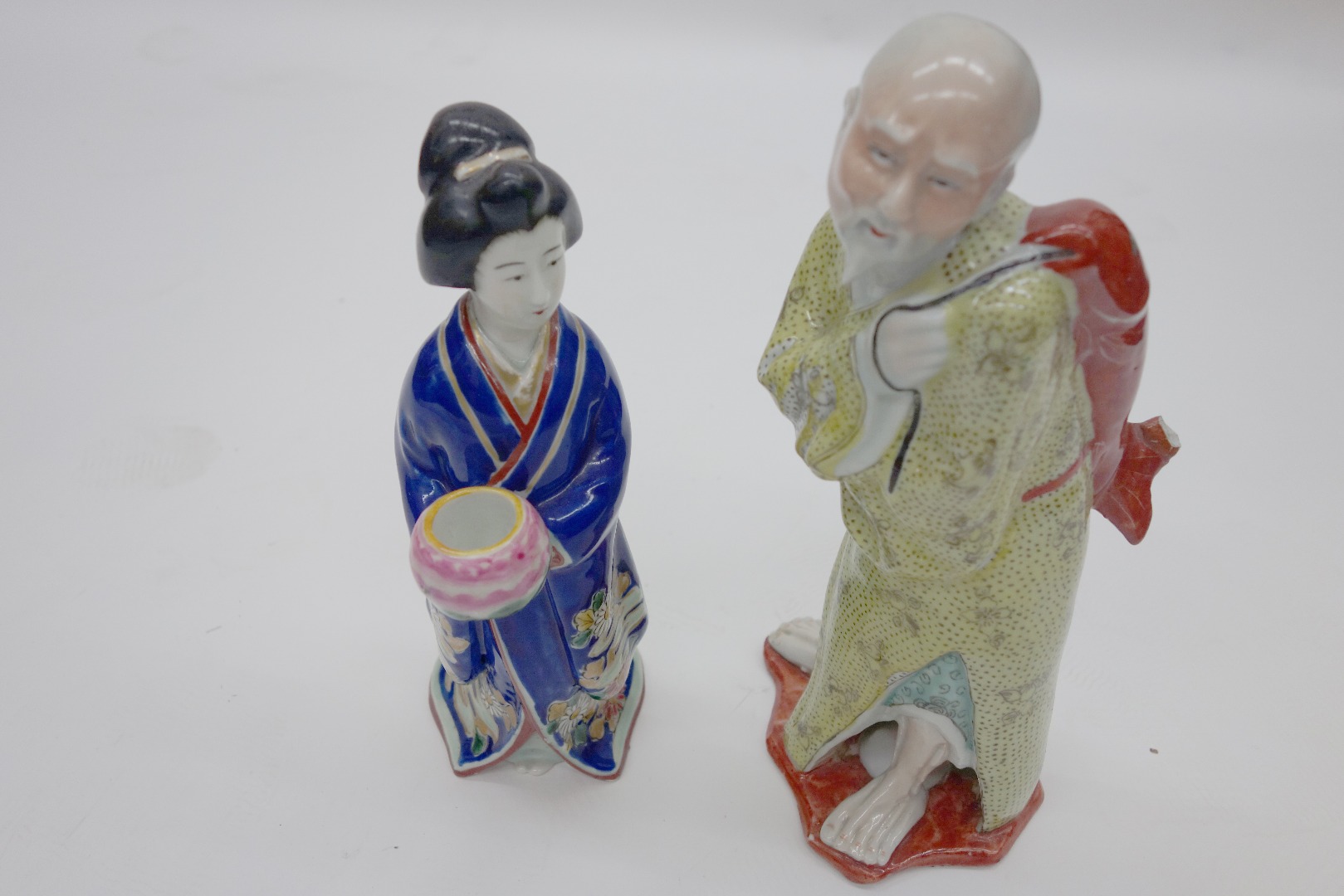 Appraisal: A Japanese Imari figure of a bijin holding a small