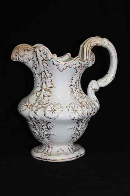 Appraisal: A VICTORIAN POTTERY FOLIATE MOULDED JUG with applied gilt decoration