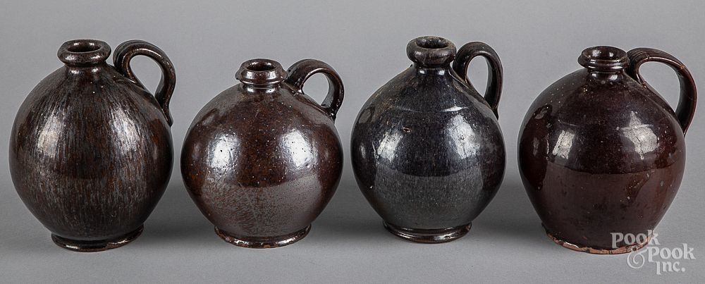 Appraisal: Four small redware ovoid jugs Four small redware ovoid jugs