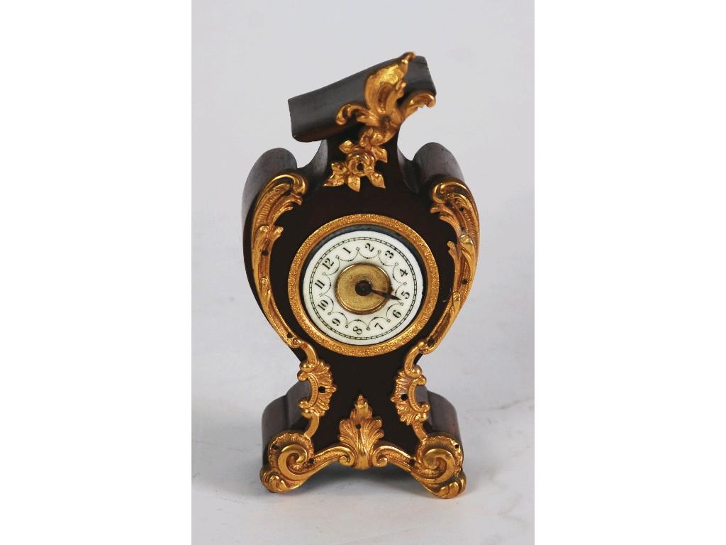 Appraisal: EARLY TWENTIETH CENTURY SMALL MANTEL CLOCK in mahogany rococo balloon