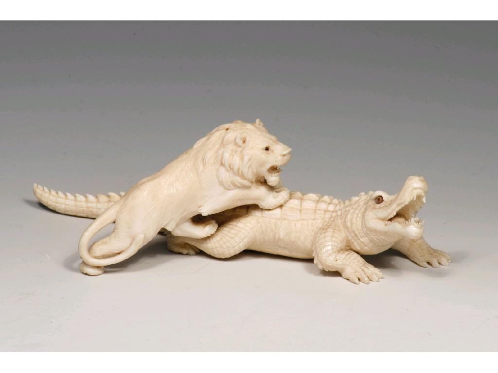 Appraisal: A JAPANESE IVORY OKIMONO of a lion and crocodile signed