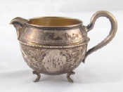 Appraisal: A Russian silver cream jug of globular shape with beaded