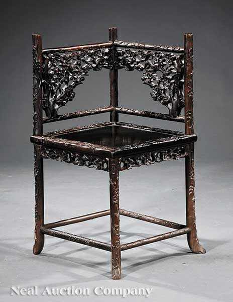 Appraisal: A Chinese Carved Hardwood Corner Chair possibly Zitan the pierced