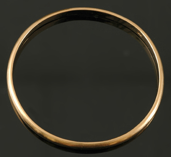 Appraisal: A gold bangle The half round bangle weighing gms set