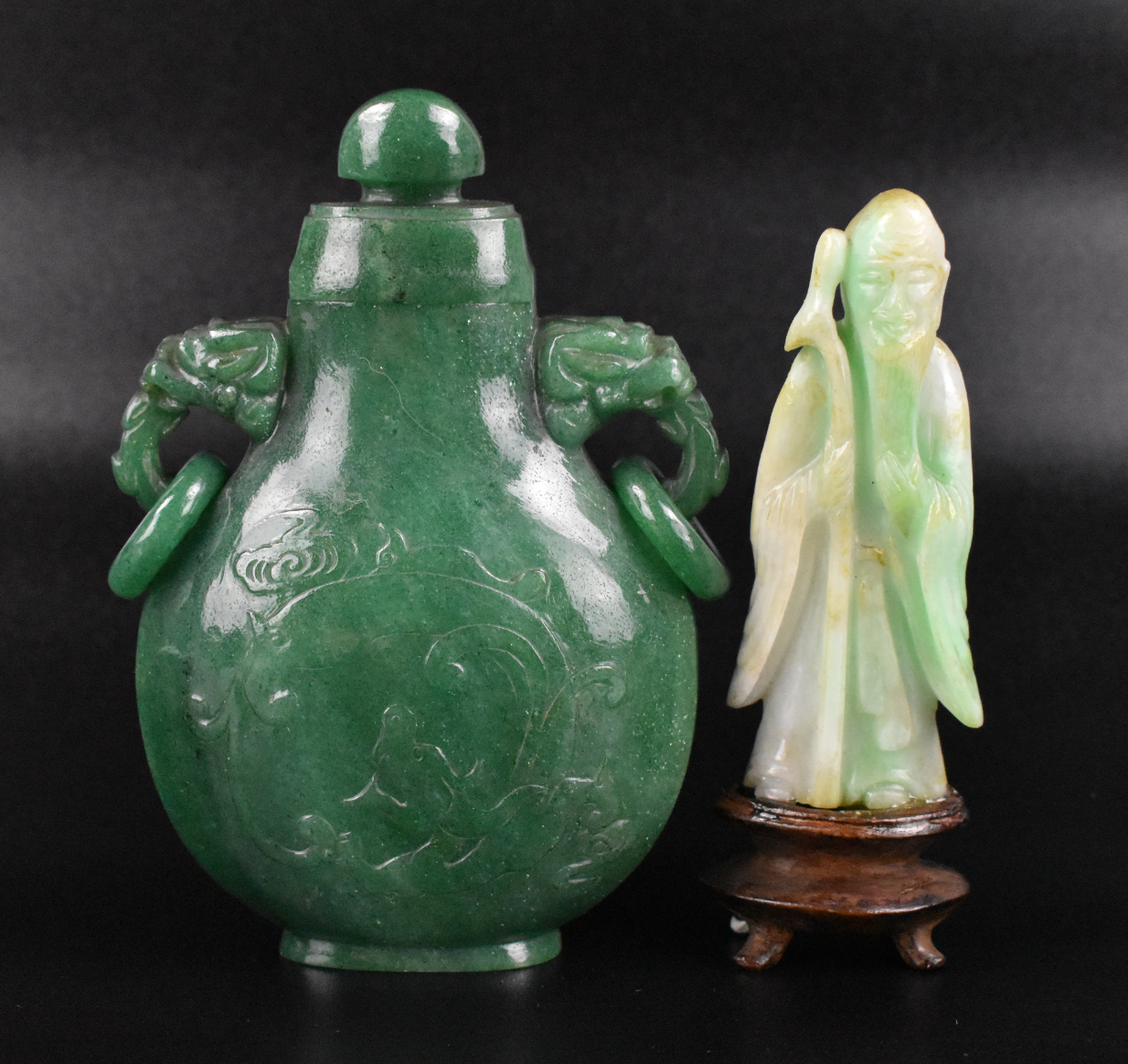 Appraisal: A Chinese jadeite carving of a standing figure and a