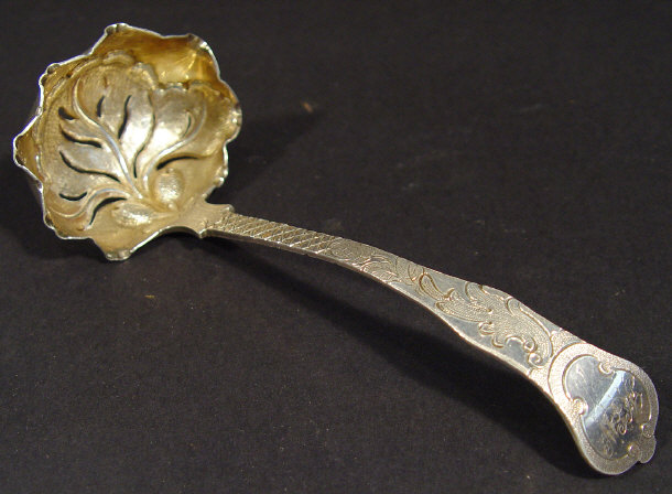 Appraisal: Georgian silver ladle the bowl embossed and pierced with leaves