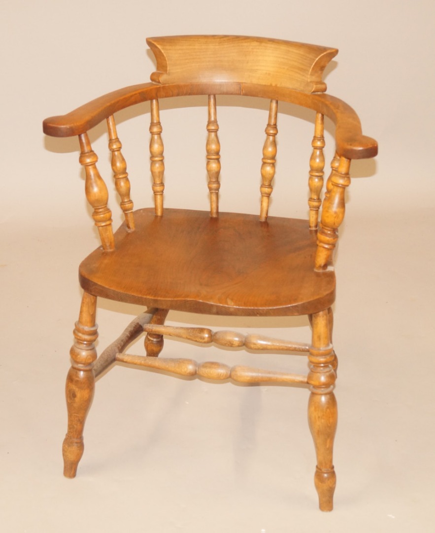 Appraisal: A thC ash and elm captain's type chair with spindle