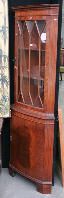 Appraisal: A George III style mahogany corner cabinet with astragal glazed