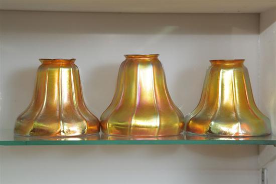 Appraisal: THREE ART GLASS SHADES Gold iridescent shades with ribbed bodies