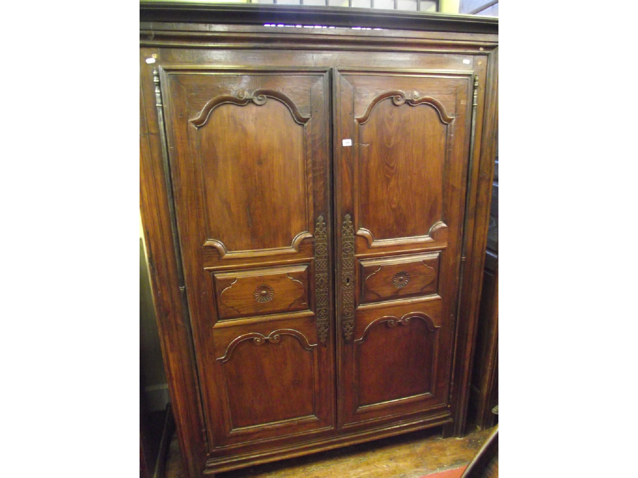 Appraisal: An th century chestnut armoire with panelled framework enclosed by