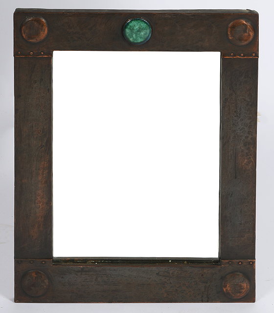 Appraisal: AN ARTS AND CRAFTS LOOKING GLASS with beaten copper rectangular