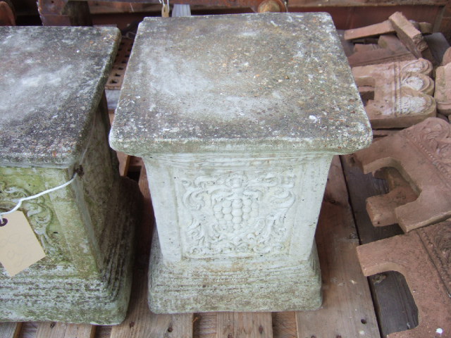 Appraisal: A pair of reconstituted stone square pedestals with grape moulded