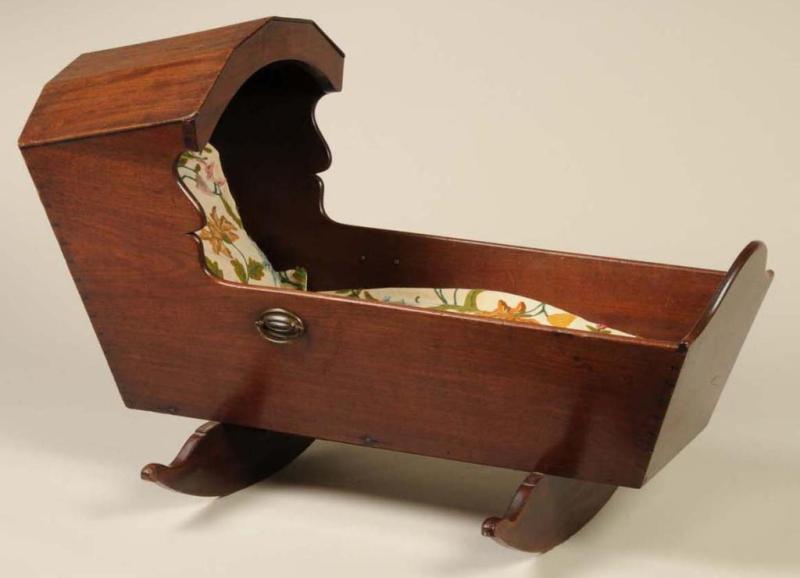 Appraisal: American Walnut Hooded Cradle Description Circa Brass side handles Size