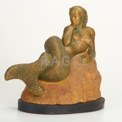 Appraisal: NANCY P DRYFOOS Stoneware sculpture of a mermaid reclining on