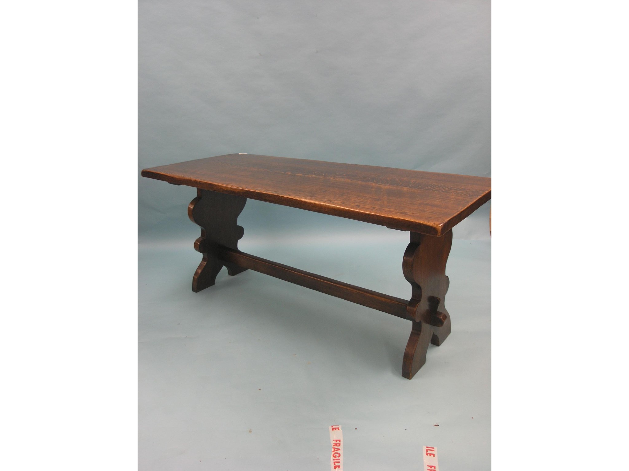 Appraisal: A solid dark oak refectory-type dining table thick four-plank top