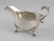 Appraisal: A silver sauce boat with hoof feet shaped rim and