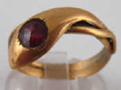 Appraisal: A yellow metal tests carat gold garnet snake ring size