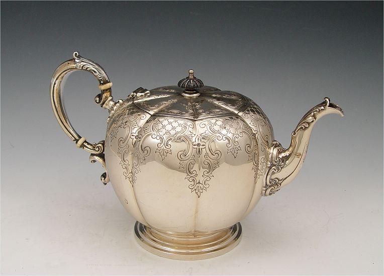 Appraisal: EMBOSSED STERLING TEAPOT Embossed foliate scroll and geometric designs with