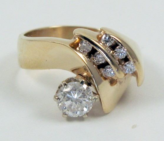 Appraisal: DIAMOND AND FOURTEEN KARAT GOLD RING set with a round