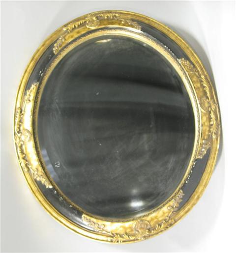 Appraisal: CLASSICAL STYLE OVAL BLACK GOLD MIRROR Late th st century