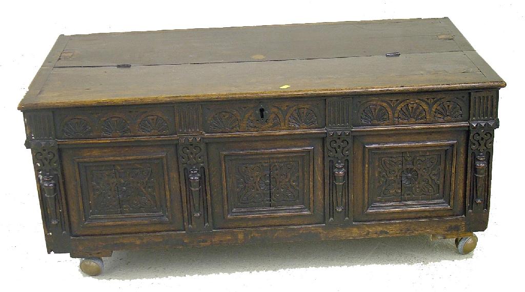 Appraisal: Antique low oak coffer the half hinged top over the