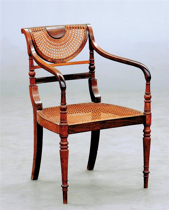 Appraisal: Regency rosewood and cane armchair circa scrolling crestrail and demilune