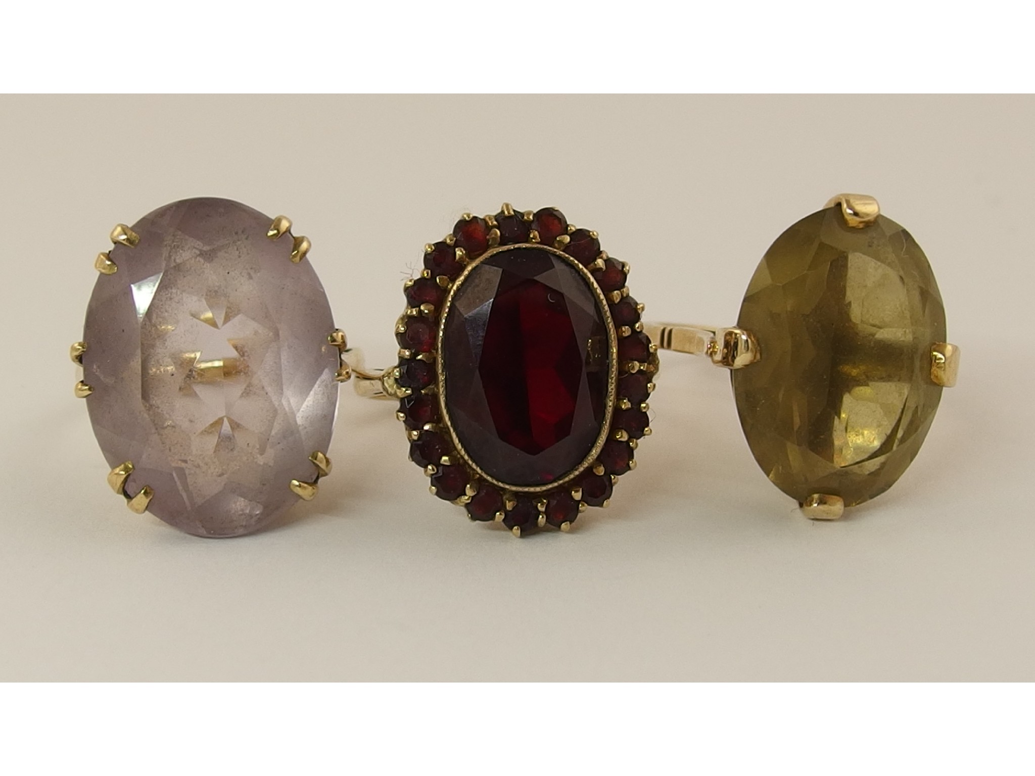 Appraisal: Three ct rings set with garnet and red glass amethyst