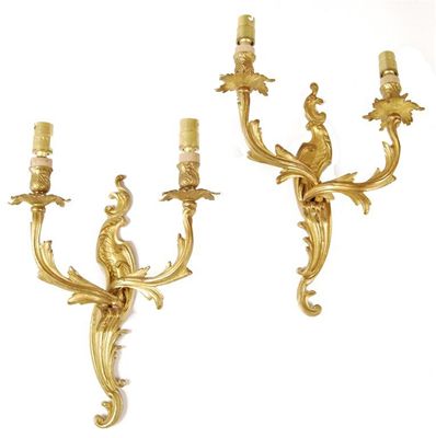 Appraisal: A pair of gilt brass twin branch wall appliques in