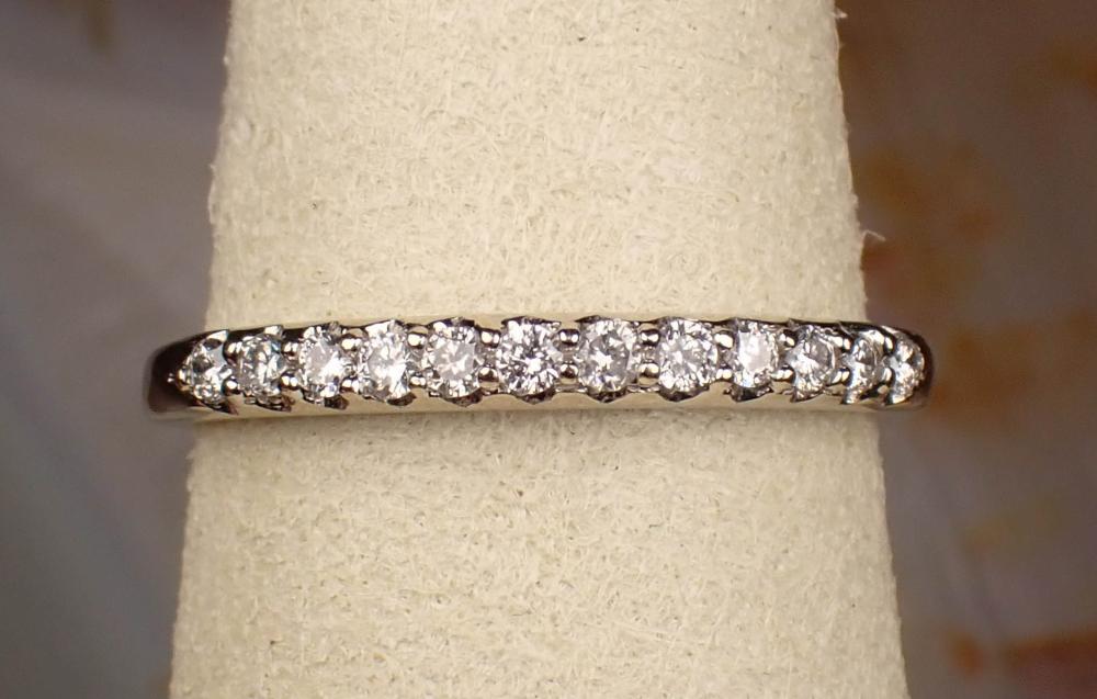 Appraisal: DIAMOND AND FOURTEEN KARAT WHITE GOLD RING set with twelve