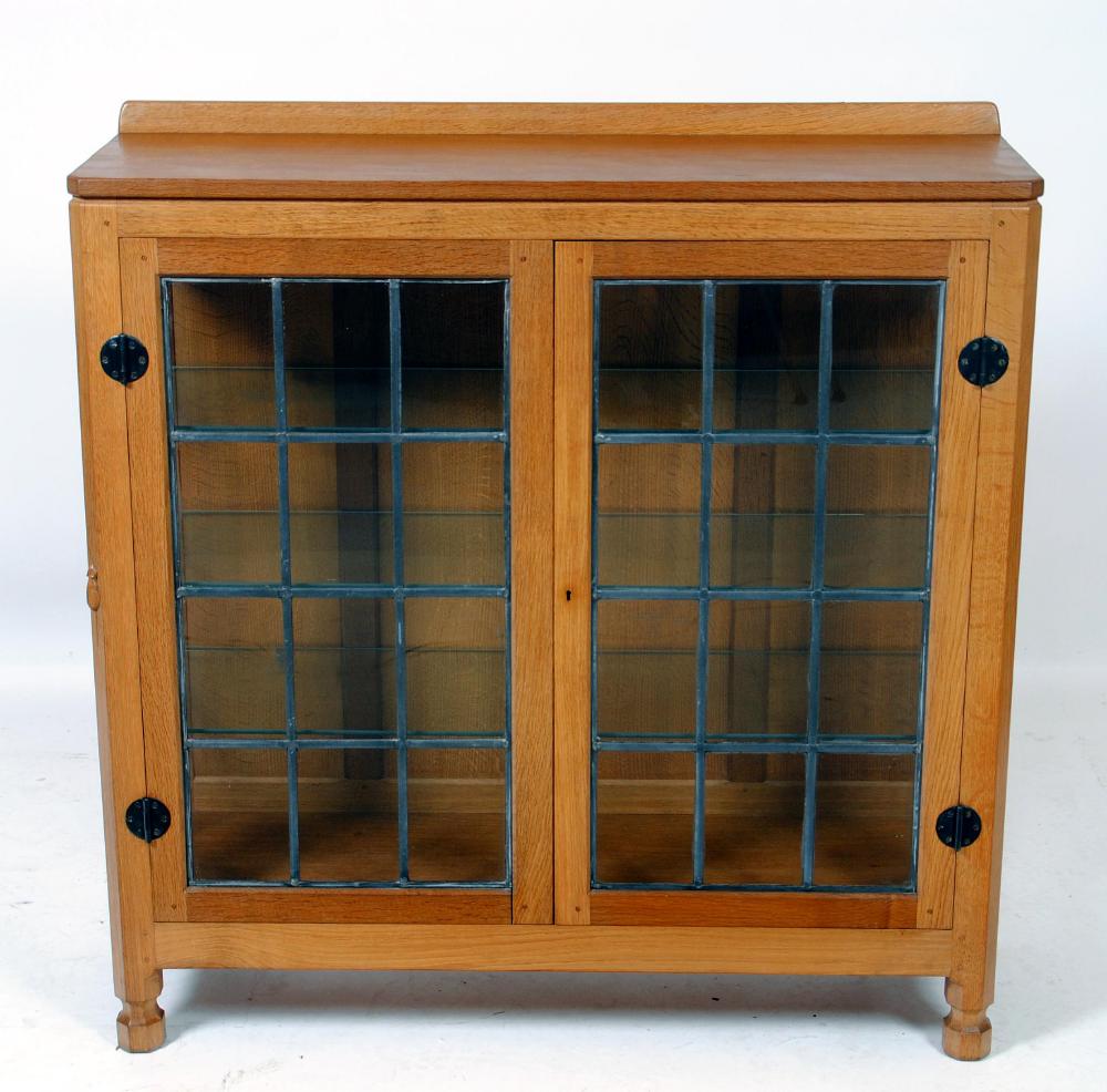 Appraisal: AN ADZED OAK DISPLAY CABINET by Robert Mouseman Thompson of