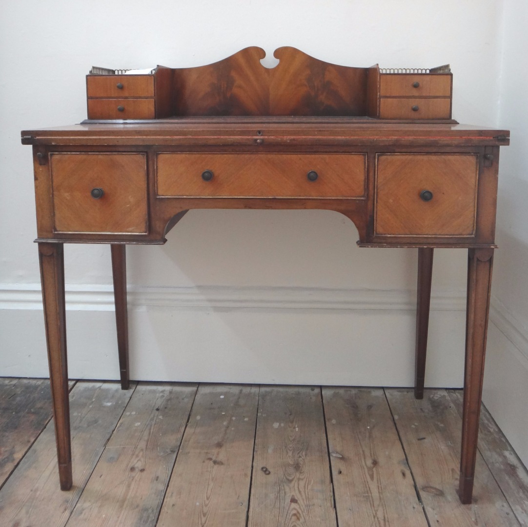 Appraisal: A reproduction George III style mahogany bonheur de jour fitted