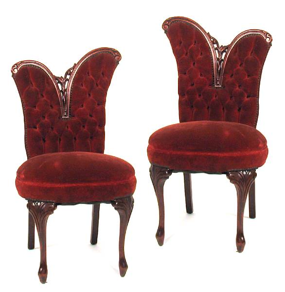 Appraisal: A pair of Austrian style carved walnut and red upholstered