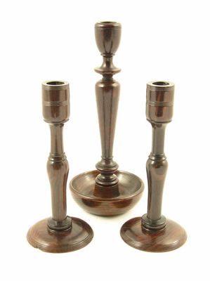 Appraisal: A pair of turned hardwood candlesticks in cm h and