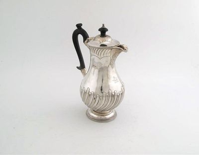 Appraisal: A late Victorian baluster hot water jug part fluted and